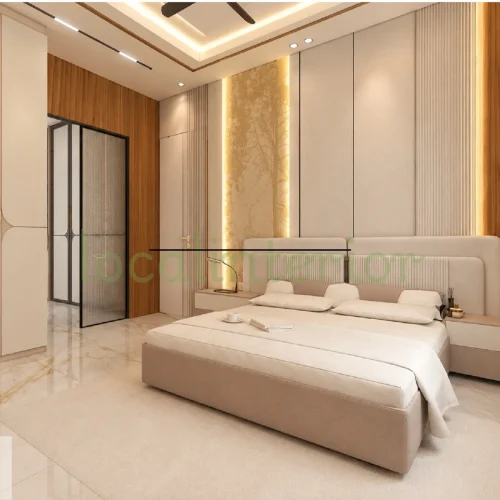 Contemporary bedroom interior featuring a neutral upholstered bed, floor-to-ceiling wardrobes, and an integrated study desk with warm ambient lighting.