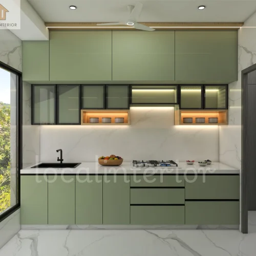Contemporary sage green modular kitchen with overhead cabinets, marble backsplash, under-cabinet lighting, and sleek storage solutions.